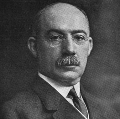 Henry L Gantt, a bald man with a mustache and glasses, depicted in an old black and white photo (scientific project management)